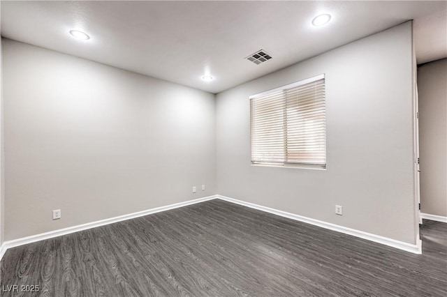 spare room with dark hardwood / wood-style floors