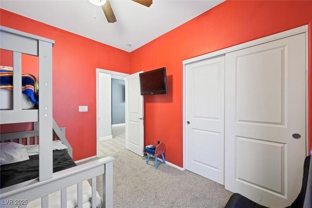 bedroom with a closet, ceiling fan, and carpet flooring