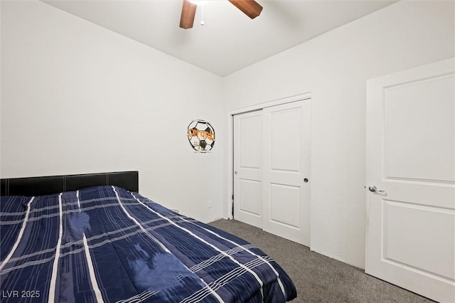 bedroom with ceiling fan, dark carpet, and a closet