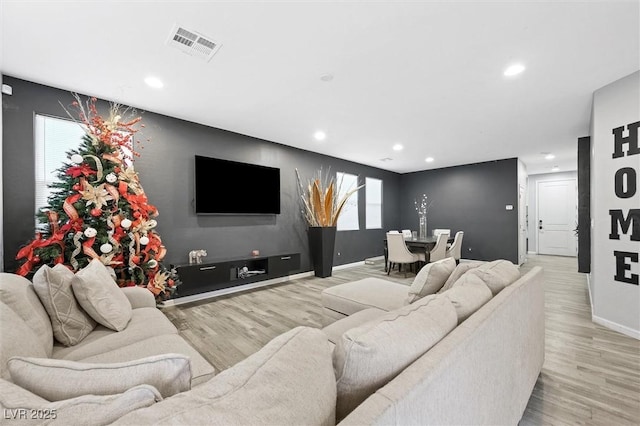 living room with a healthy amount of sunlight and light wood-type flooring