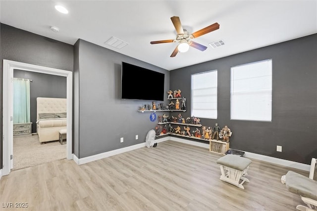 playroom with ceiling fan and light hardwood / wood-style floors