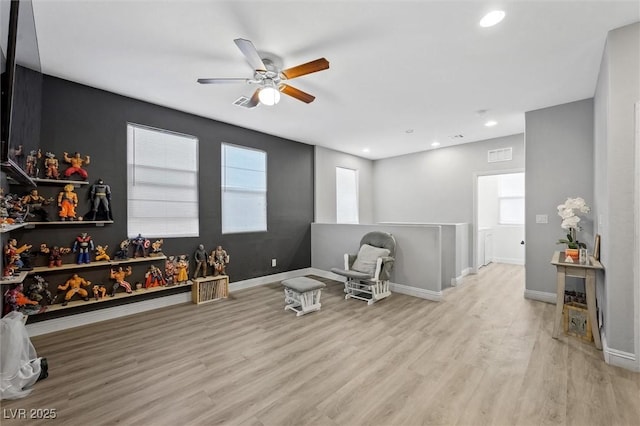 living area featuring plenty of natural light and light hardwood / wood-style floors