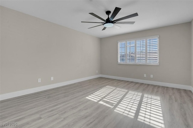 spare room featuring light hardwood / wood-style floors and ceiling fan