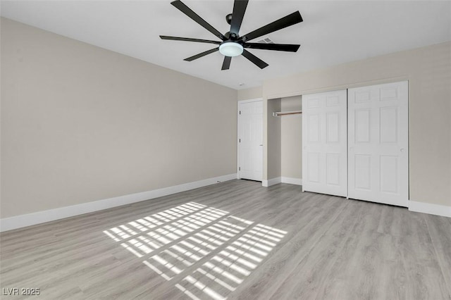 unfurnished bedroom with light wood-type flooring, ceiling fan, and a closet