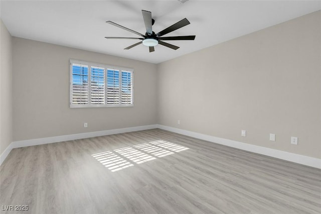 empty room with ceiling fan and light hardwood / wood-style floors