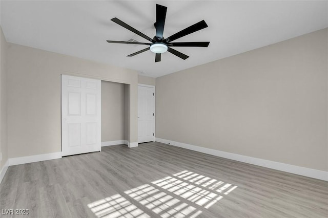 unfurnished bedroom with ceiling fan, a closet, and light wood-type flooring