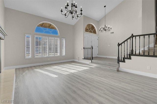 foyer featuring a chandelier and high vaulted ceiling