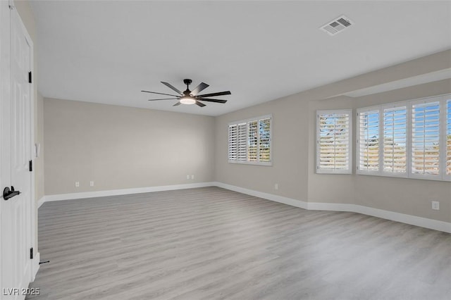 spare room with ceiling fan and light wood-type flooring