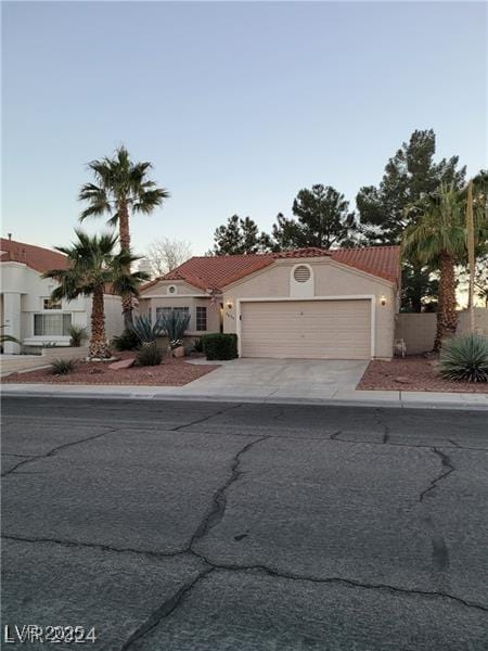 mediterranean / spanish home featuring a garage