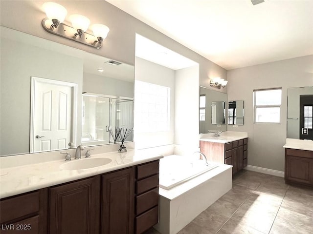 bathroom featuring vanity, independent shower and bath, and tile patterned flooring