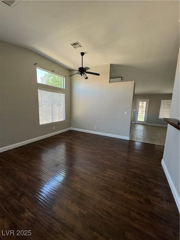 empty room with dark wood-type flooring and ceiling fan