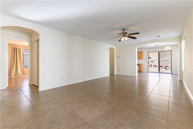 spare room featuring tile patterned flooring and ceiling fan