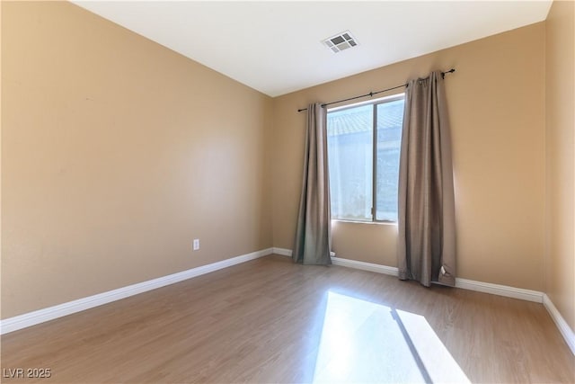 unfurnished room featuring a healthy amount of sunlight and light hardwood / wood-style floors