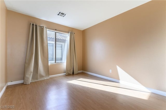 spare room featuring light hardwood / wood-style flooring