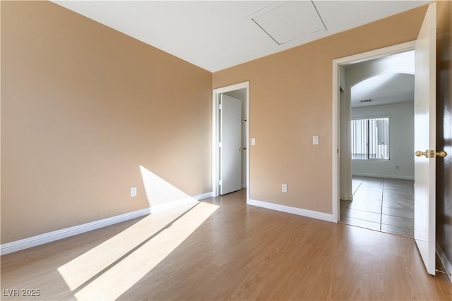 spare room with light hardwood / wood-style flooring