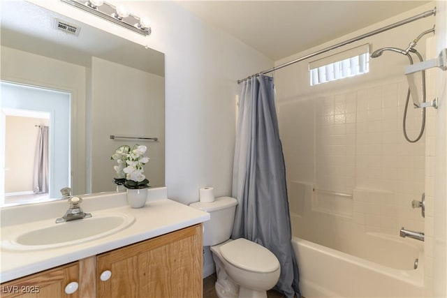 full bathroom with shower / bath combo, vanity, and toilet