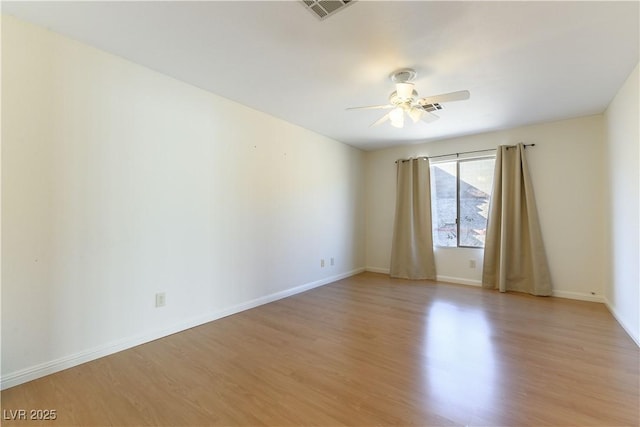 empty room featuring light hardwood / wood-style flooring and ceiling fan