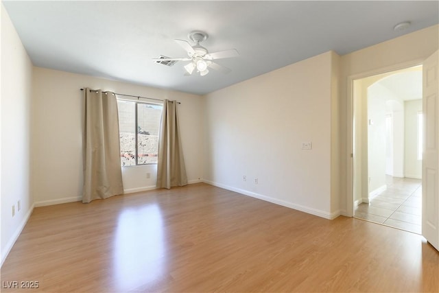 spare room featuring ceiling fan and light hardwood / wood-style floors