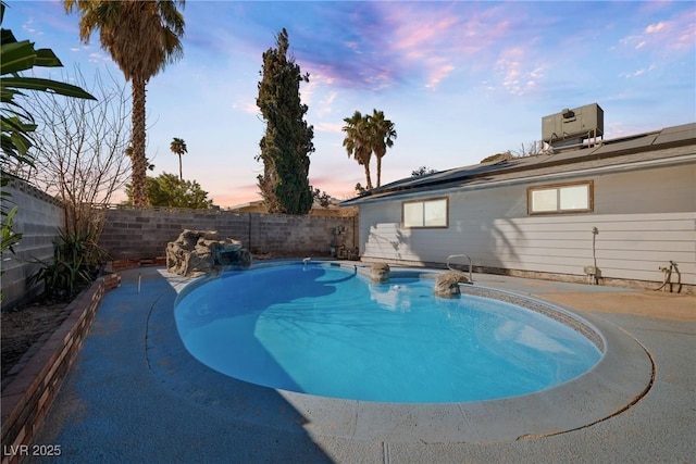 pool at dusk featuring central air condition unit