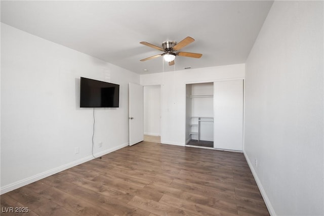 unfurnished bedroom featuring ceiling fan, wood-type flooring, and a closet