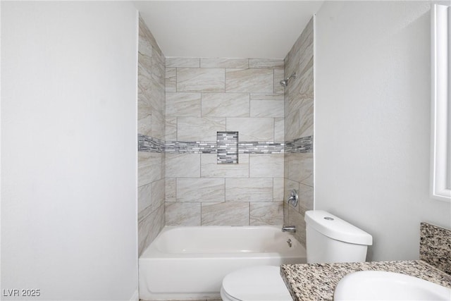 full bathroom with tiled shower / bath combo, vanity, and toilet