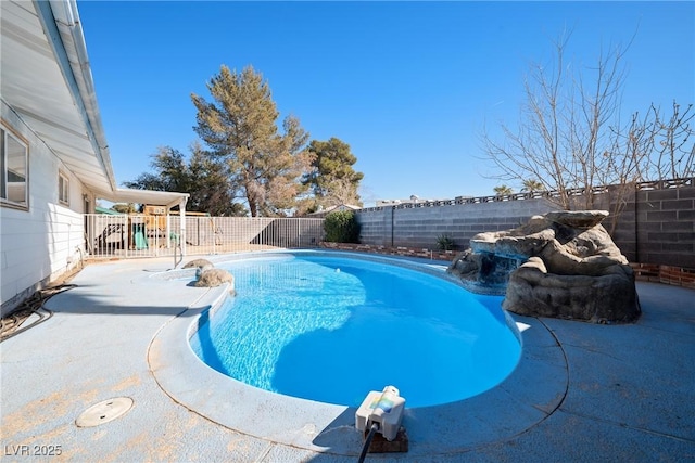 view of swimming pool with pool water feature