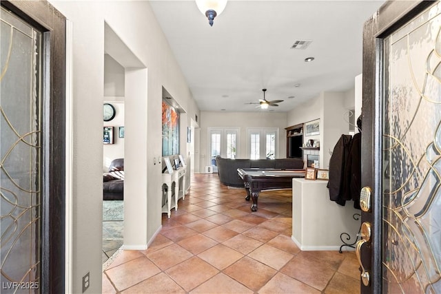 entrance foyer with ceiling fan, pool table, and light tile patterned floors