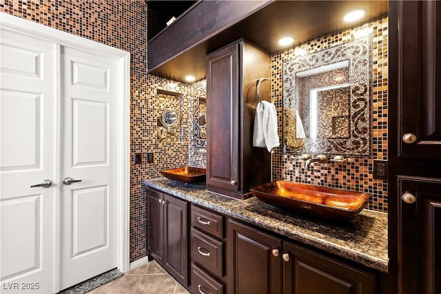 bathroom featuring vanity, tile walls, tile patterned floors, and decorative backsplash