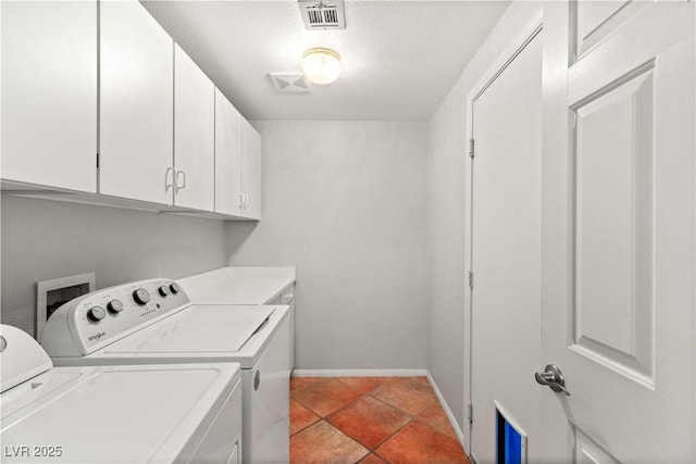 laundry room featuring cabinets, separate washer and dryer, and light tile patterned floors