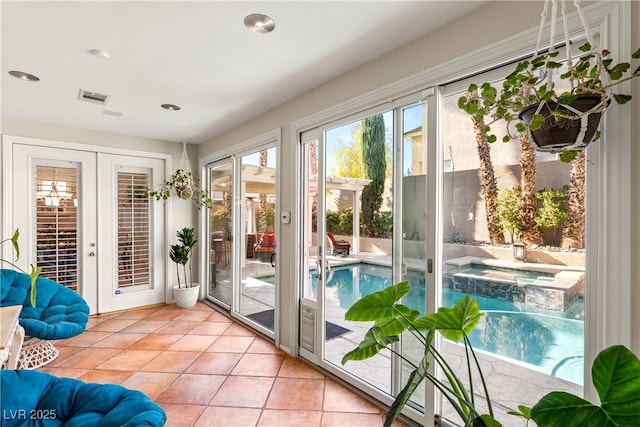 doorway to outside with light tile patterned flooring and french doors