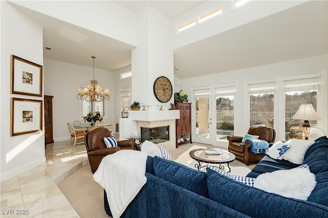 living room with a notable chandelier and a towering ceiling