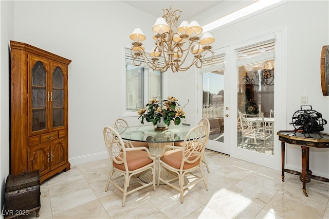 dining space featuring french doors and a chandelier