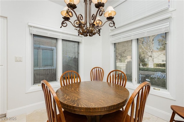 tiled dining room with a notable chandelier