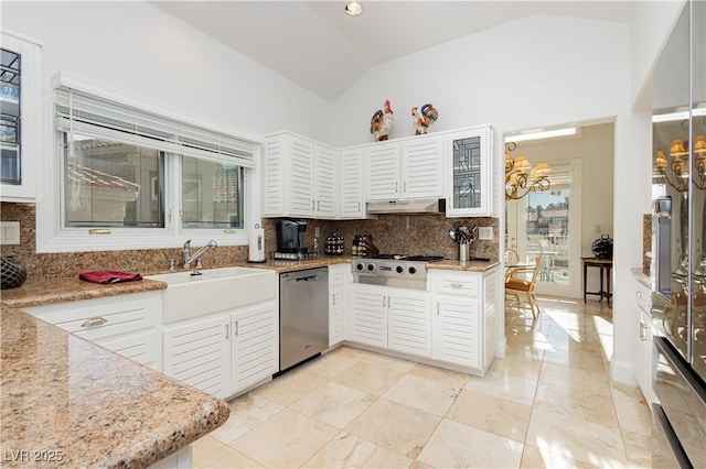 kitchen with sink, vaulted ceiling, stainless steel appliances, and light stone countertops