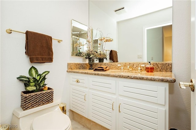 bathroom with vanity and toilet