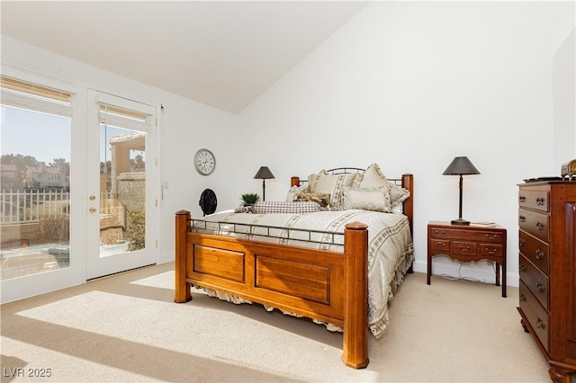 bedroom featuring french doors, light colored carpet, vaulted ceiling, and access to outside