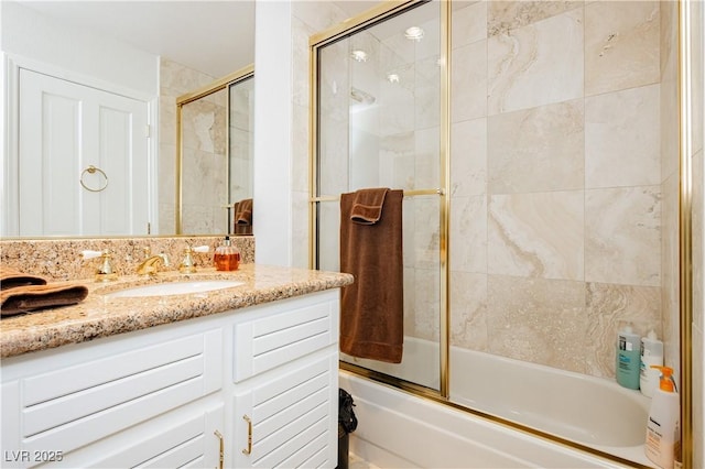 bathroom with enclosed tub / shower combo and vanity