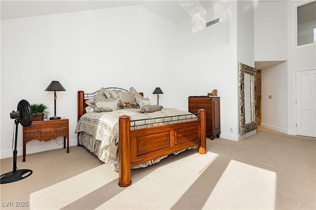 carpeted bedroom featuring high vaulted ceiling