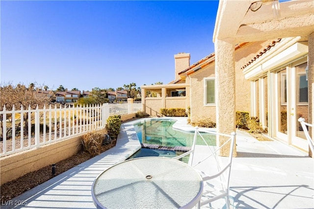 view of patio / terrace featuring a fenced in pool