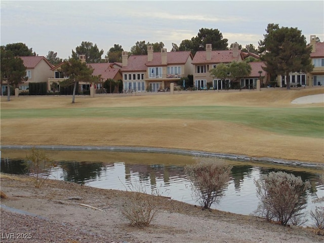 view of community with a water view and a lawn