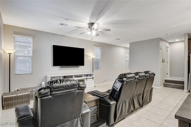 tiled cinema room featuring ceiling fan