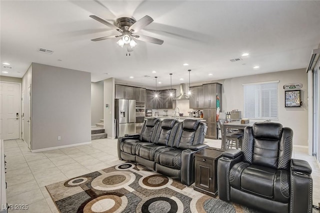 living room with light tile patterned flooring and ceiling fan