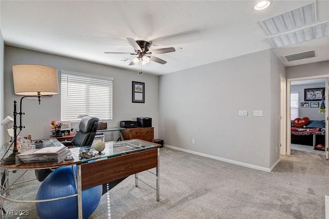 carpeted office space featuring ceiling fan