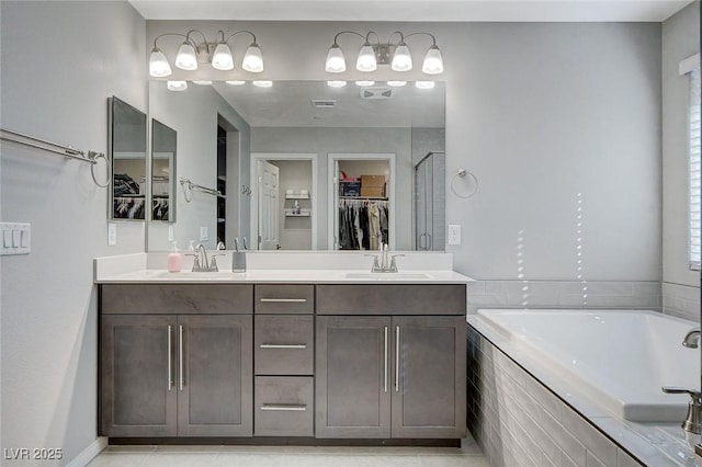 bathroom with vanity, tile patterned floors, and plus walk in shower