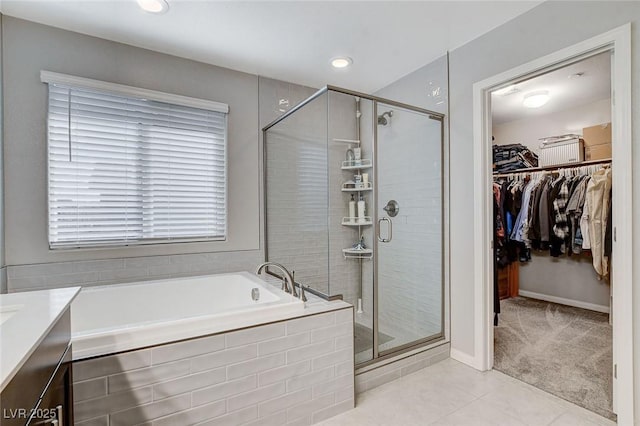 bathroom with tile patterned flooring, vanity, and separate shower and tub