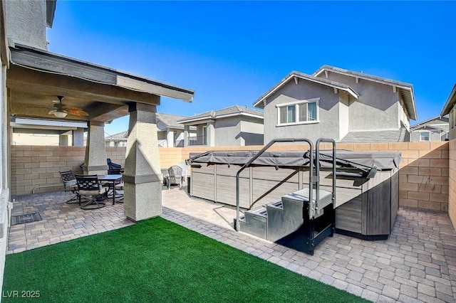 exterior space with a patio area, a hot tub, and ceiling fan