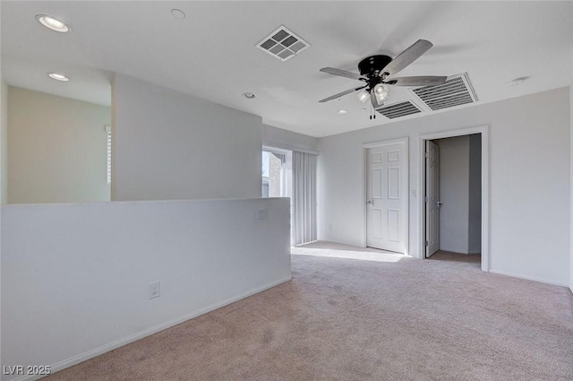 carpeted spare room with ceiling fan