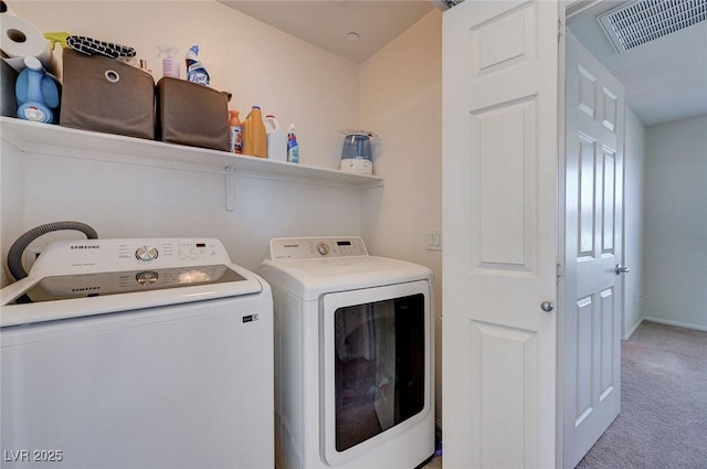 laundry room with light colored carpet and washing machine and clothes dryer