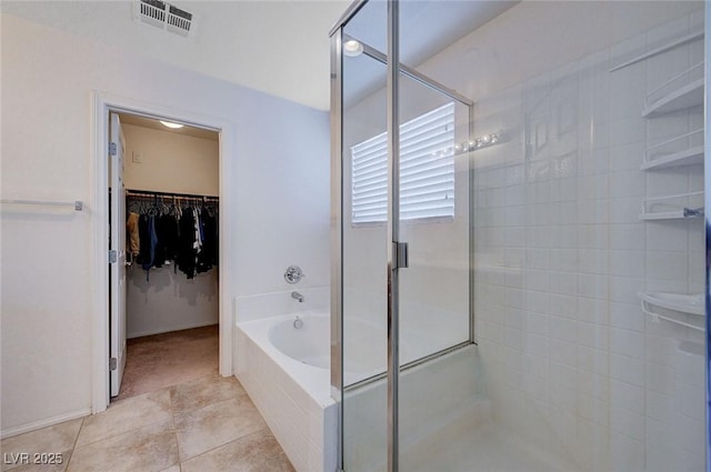 bathroom with tile patterned flooring and shower with separate bathtub