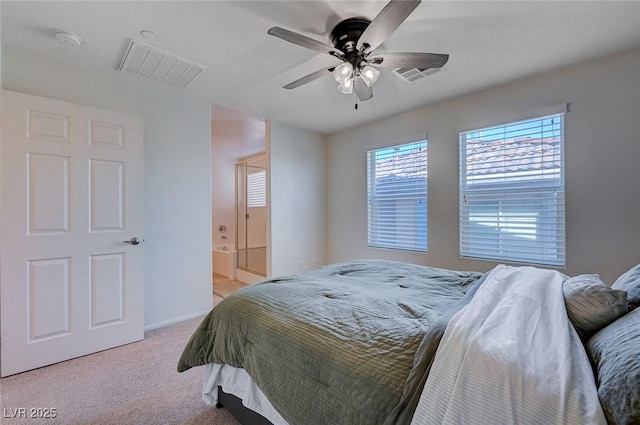 carpeted bedroom featuring ensuite bath and ceiling fan